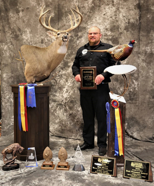 Lance Johnson of Willow Creek Taxidermy with some of his many accolades